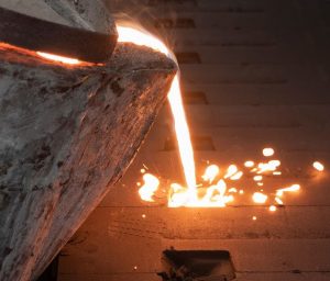 Image of metal pouring into sand castings showing The Advantages of Using Sand Casting